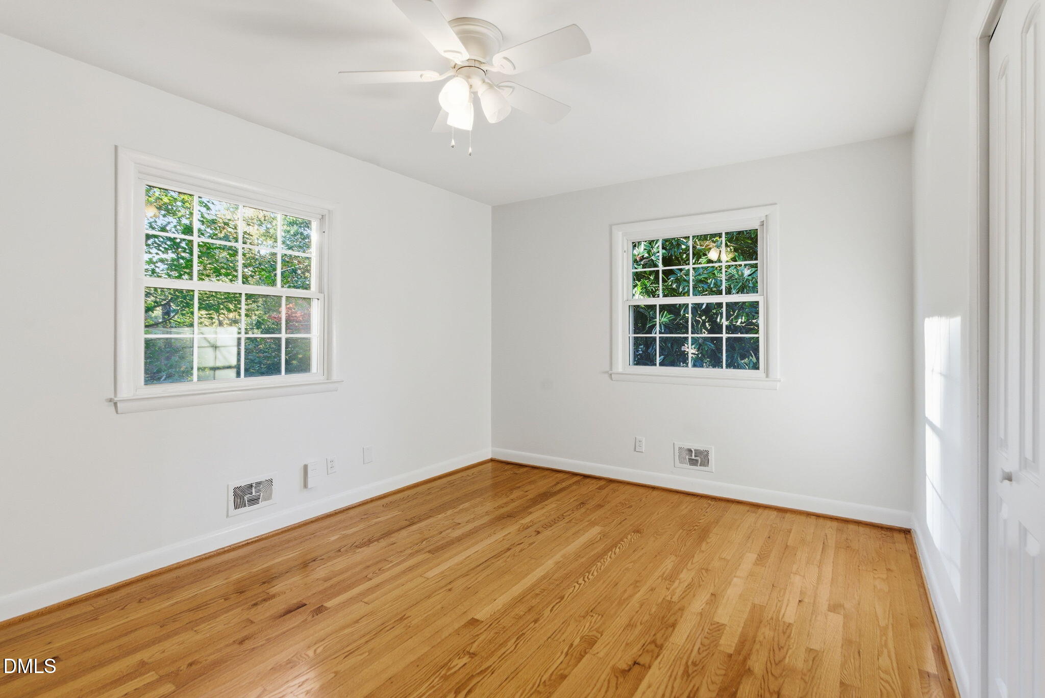 531 West Cornwall Road Cary, NC 27511 - Photo 35 of 77 a view of empty room with wooden floor and fan