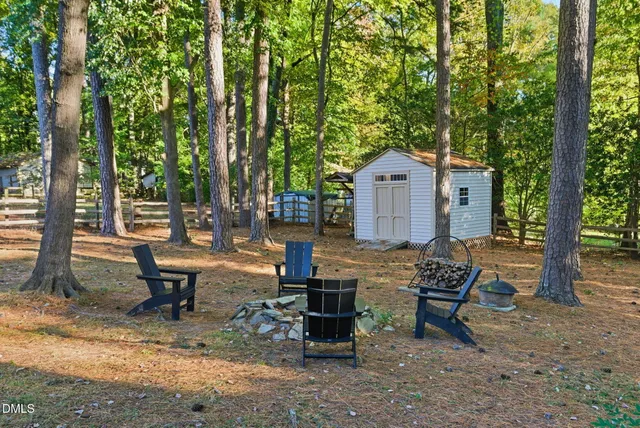 a front view of a house with garden and sitting area