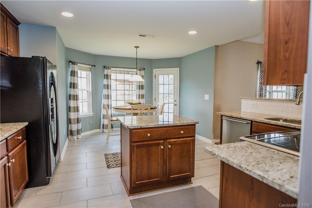 1735 Newland Road Denver, NC 28037 - Photo 6 of 24 a kitchen with a refrigerator and countertop