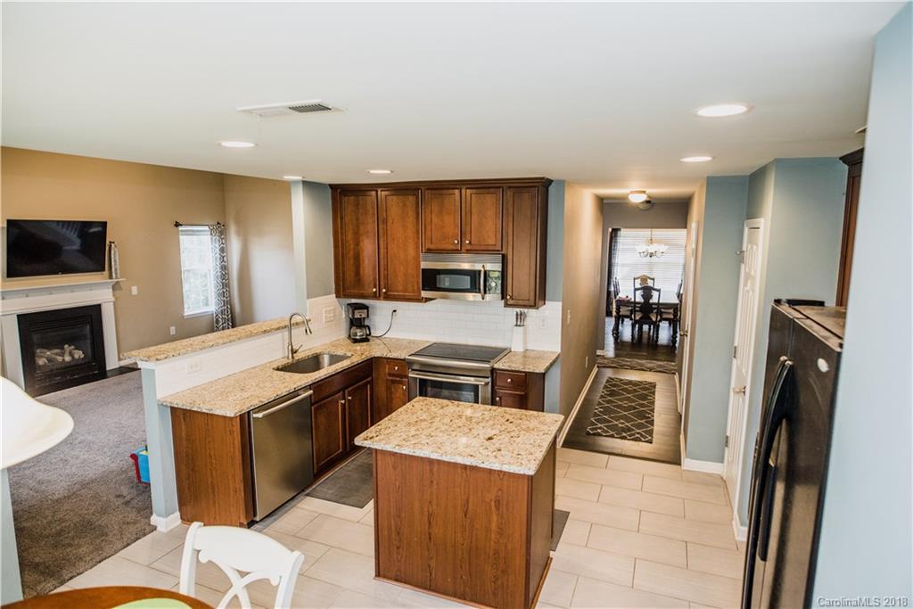 1735 Newland Road Denver, NC 28037 - Photo 7 of 24 a kitchen with a stove sink and a refrigerator
