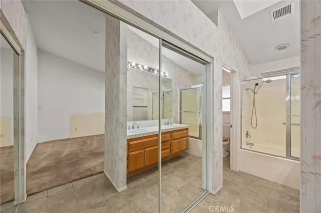 a bathroom with a double vanity sink mirror double and shower