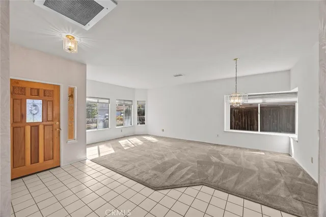 a view of a room with windows and chandelier