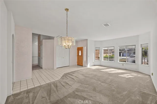 a large kitchen with stainless steel appliances kitchen island granite countertop a refrigerator and a stove top oven