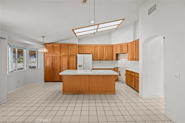 a kitchen with a stove a sink dishwasher and a refrigerator