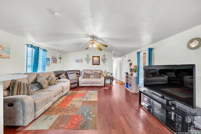 a living room with furniture and wooden floor