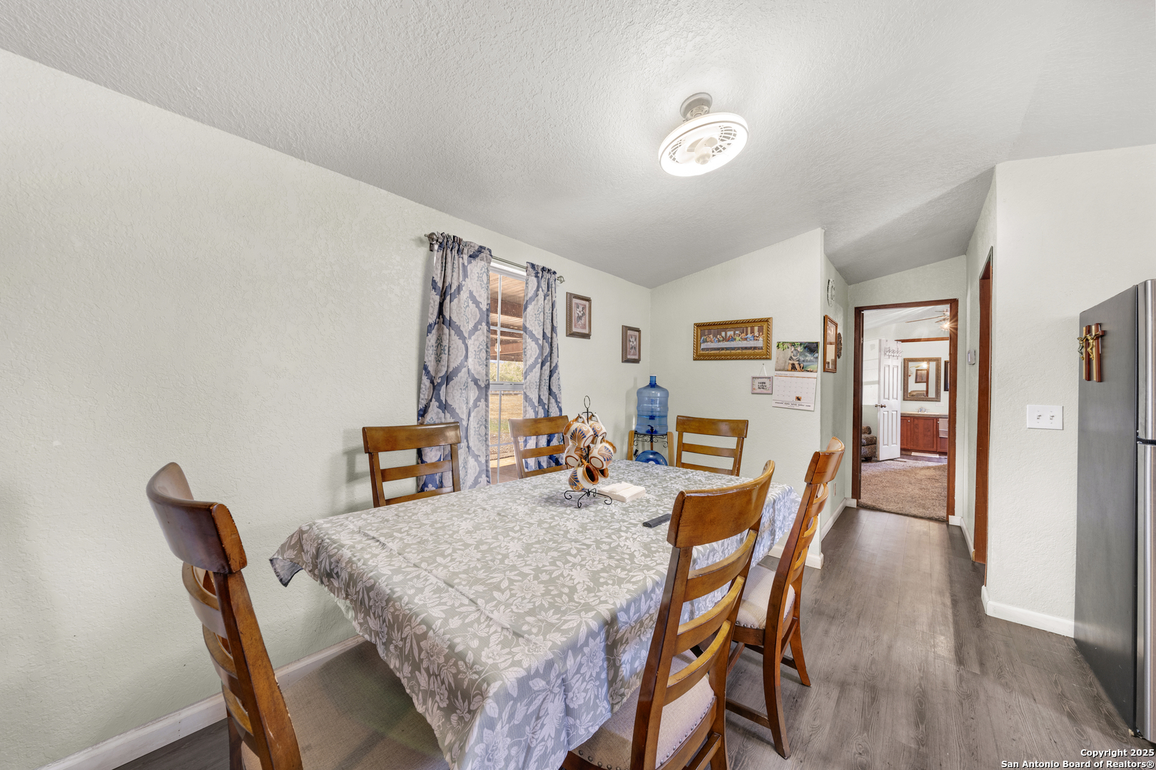11791 Kinney Road Atascosa, TX 78002 - Photo 22 of 28 a dining room with furniture and wooden floor