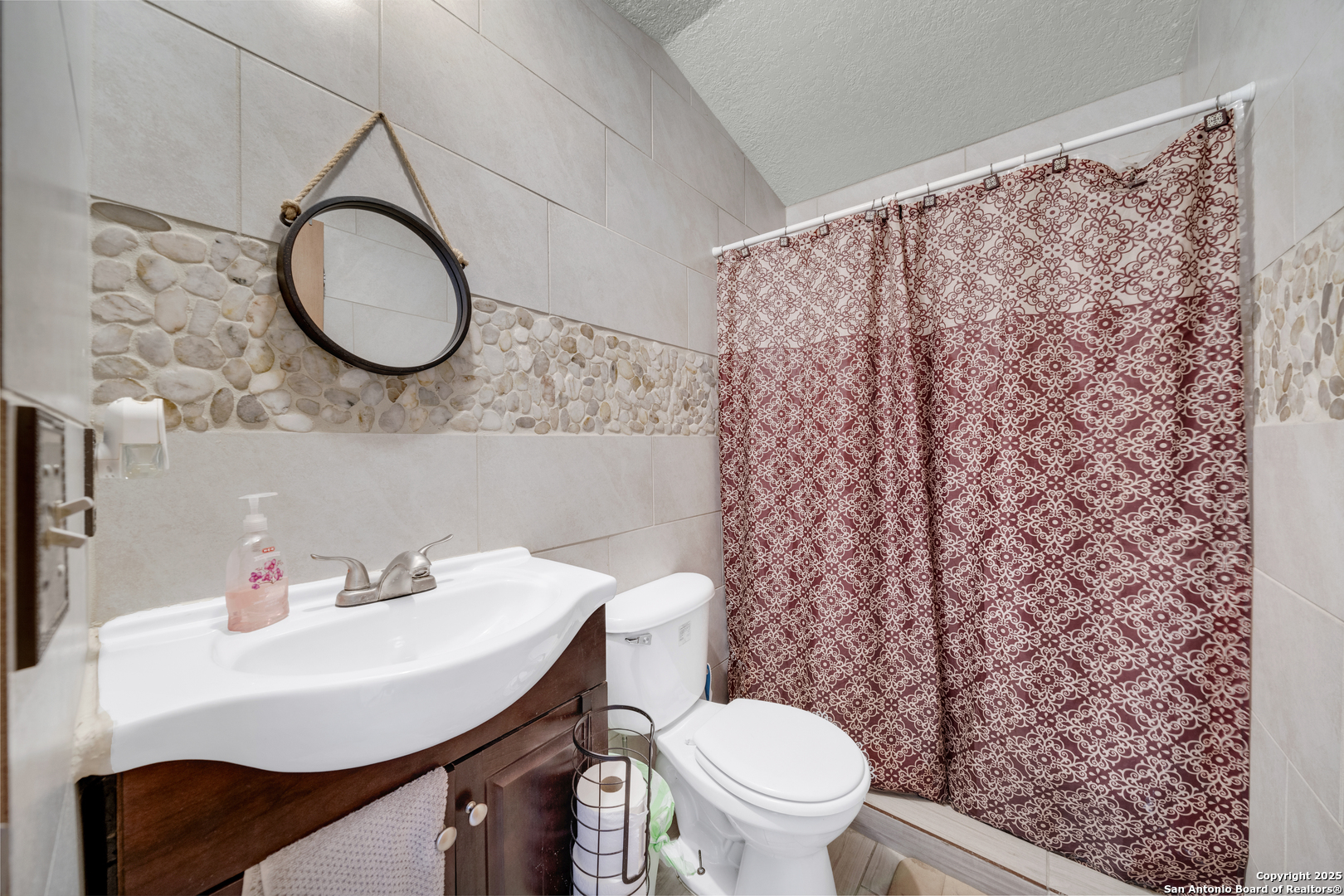 11791 Kinney Road Atascosa, TX 78002 - Photo 27 of 28 a bathroom with a sink a toilet and a mirror