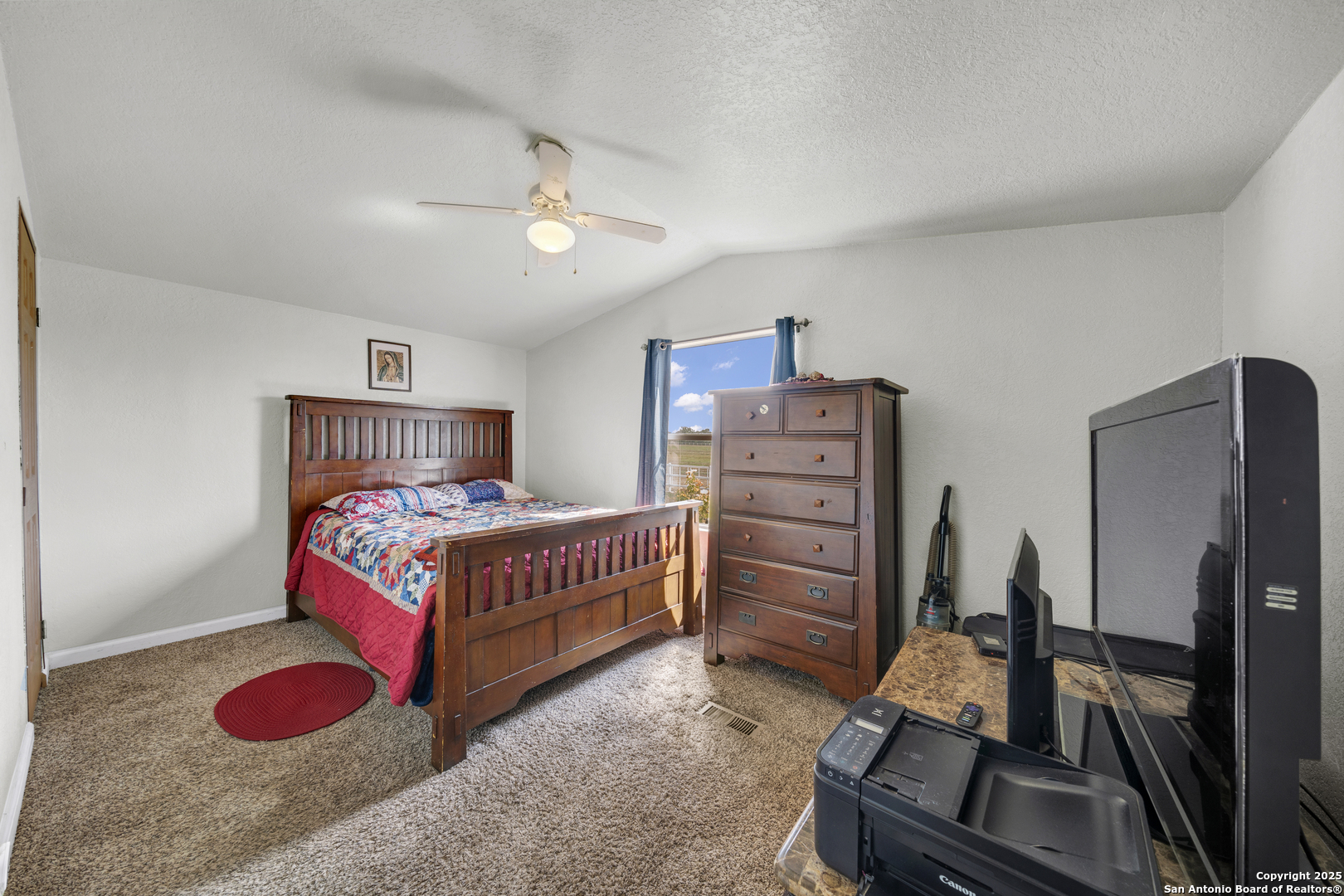 11791 Kinney Road Atascosa, TX 78002 - Photo 28 of 28 a bedroom with a bed and wooden floor