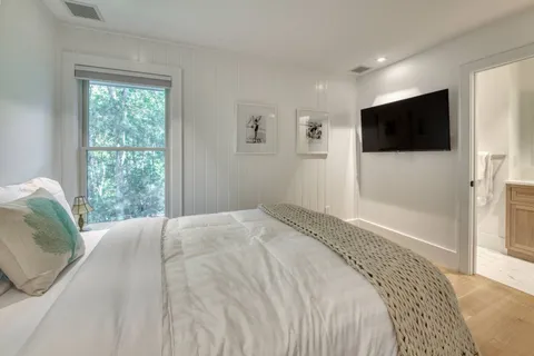 a bedroom with a bed and a flat screen tv