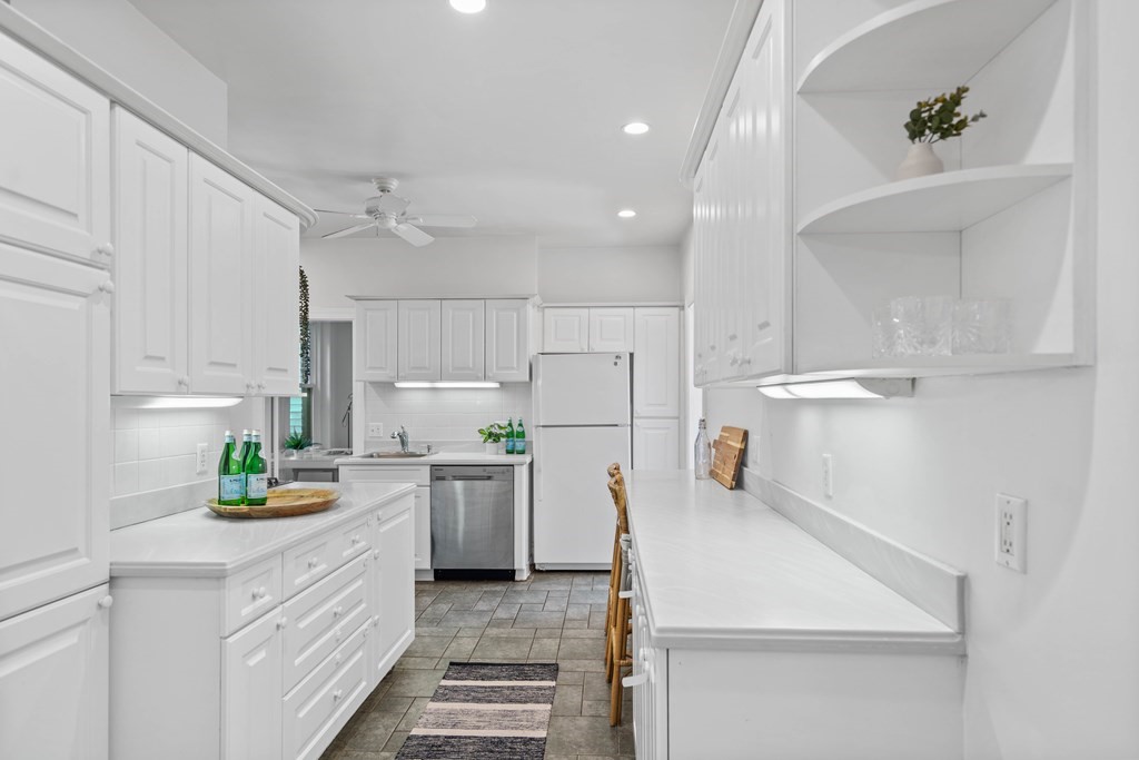 311 Tappan Street, Unit 2 Brookline, MA 02445 - Photo 13 of 26 a kitchen with a white stove top oven a white counter space and cabinets