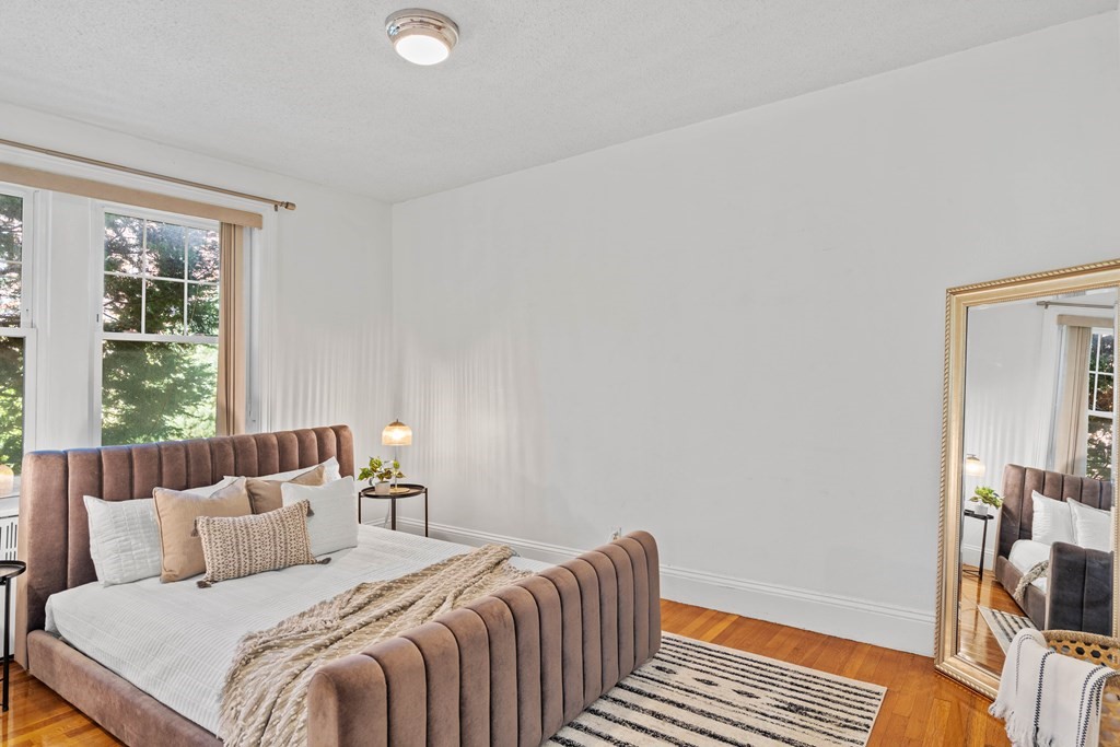 311 Tappan Street, Unit 2 Brookline, MA 02445 - Photo 20 of 26 a bedroom with a bed and wooden floor