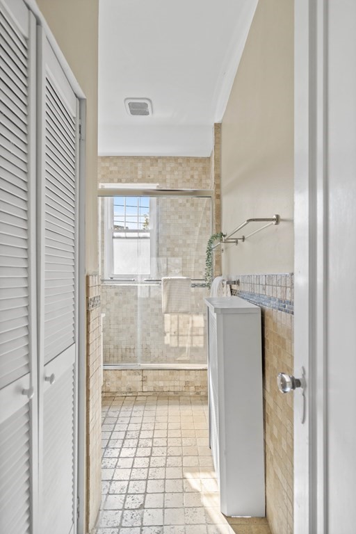 311 Tappan Street, Unit 2 Brookline, MA 02445 - Photo 22 of 26 a bathroom with a glass door shower and a sink