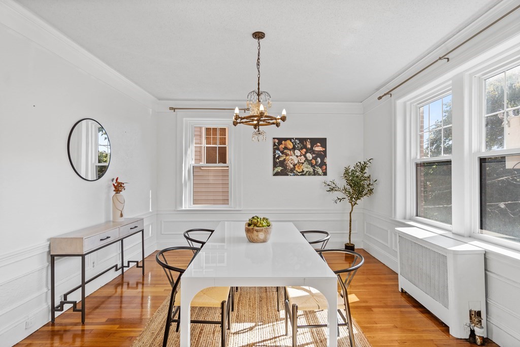 311 Tappan Street, Unit 2 Brookline, MA 02445 - Photo 10 of 26 a dining room with furniture a chandelier and wooden floor