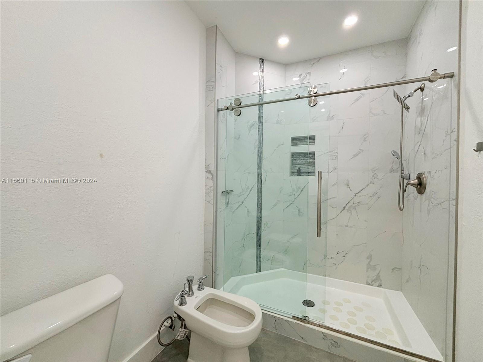 10860 Northwest 84th Street Doral, FL 33178 - Photo 11 of 19 a bathroom with a sink a toilet and shower