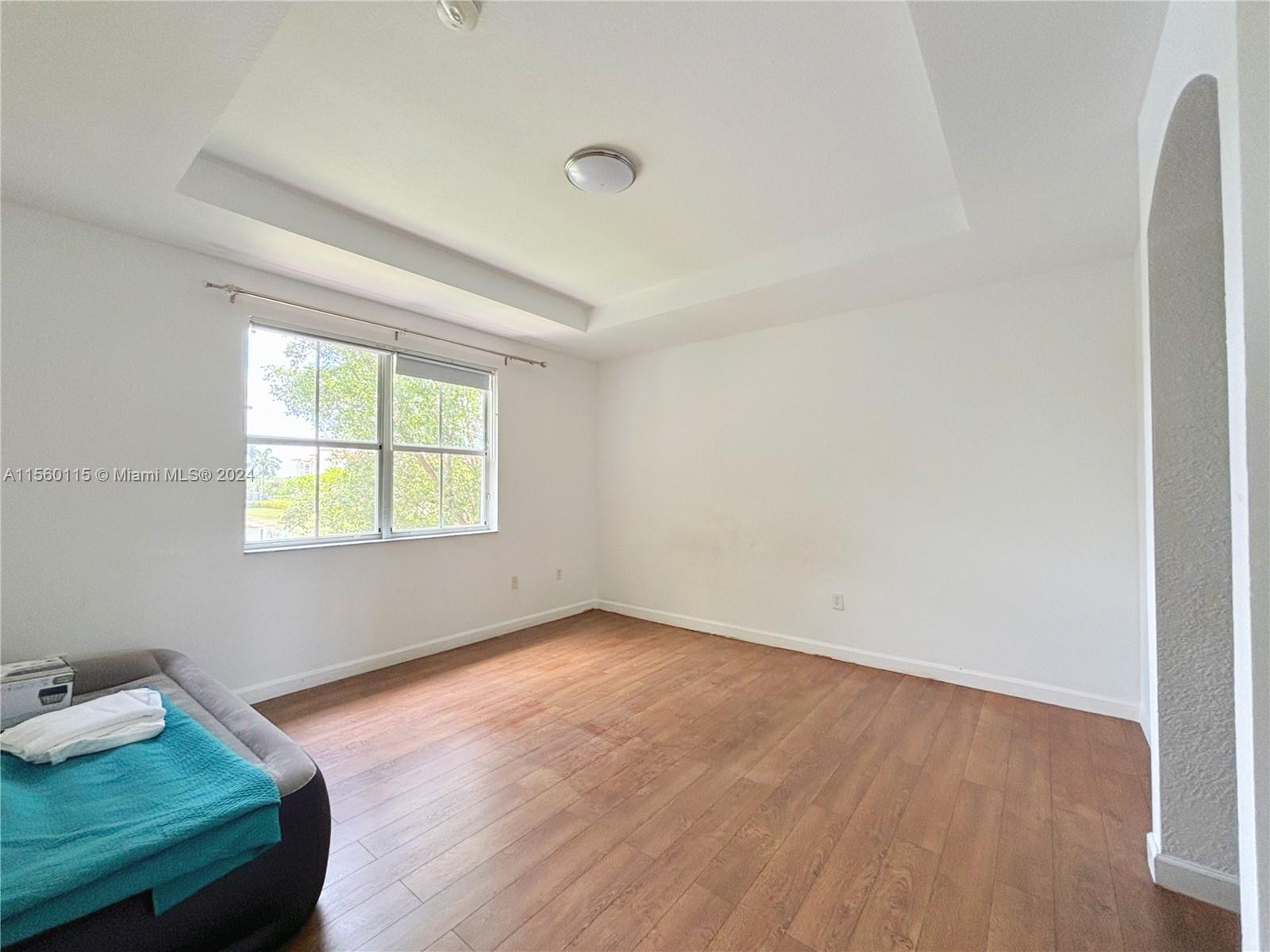 10860 Northwest 84th Street Doral, FL 33178 - Photo 12 of 19 an empty room with wooden floor and windows