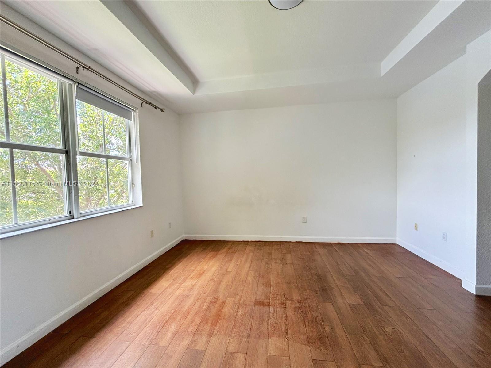 10860 Northwest 84th Street Doral, FL 33178 - Photo 13 of 19 wooden floor in an empty room with a window