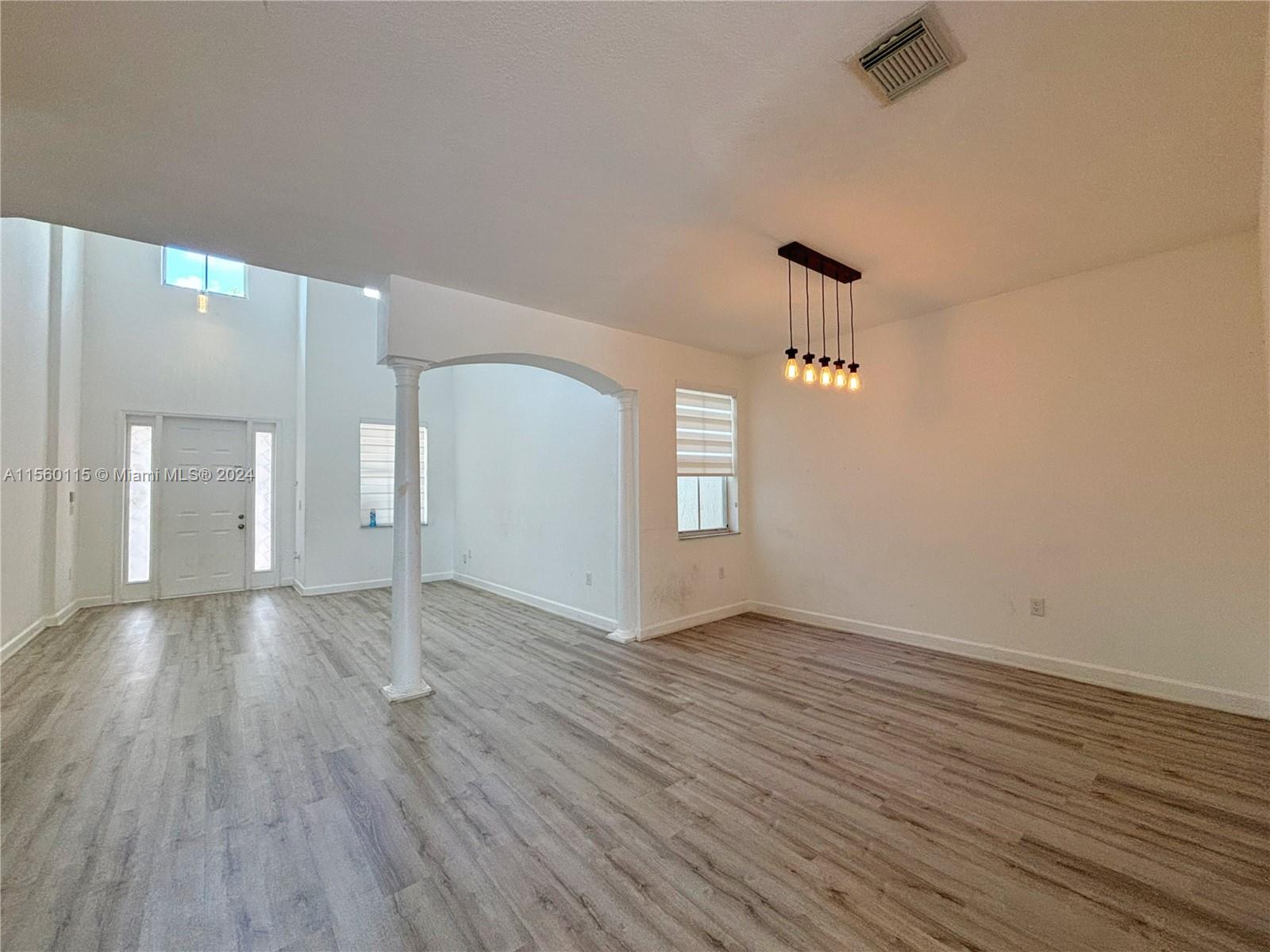 10860 Northwest 84th Street Doral, FL 33178 - Photo 17 of 19 wooden floor in an empty room with a window