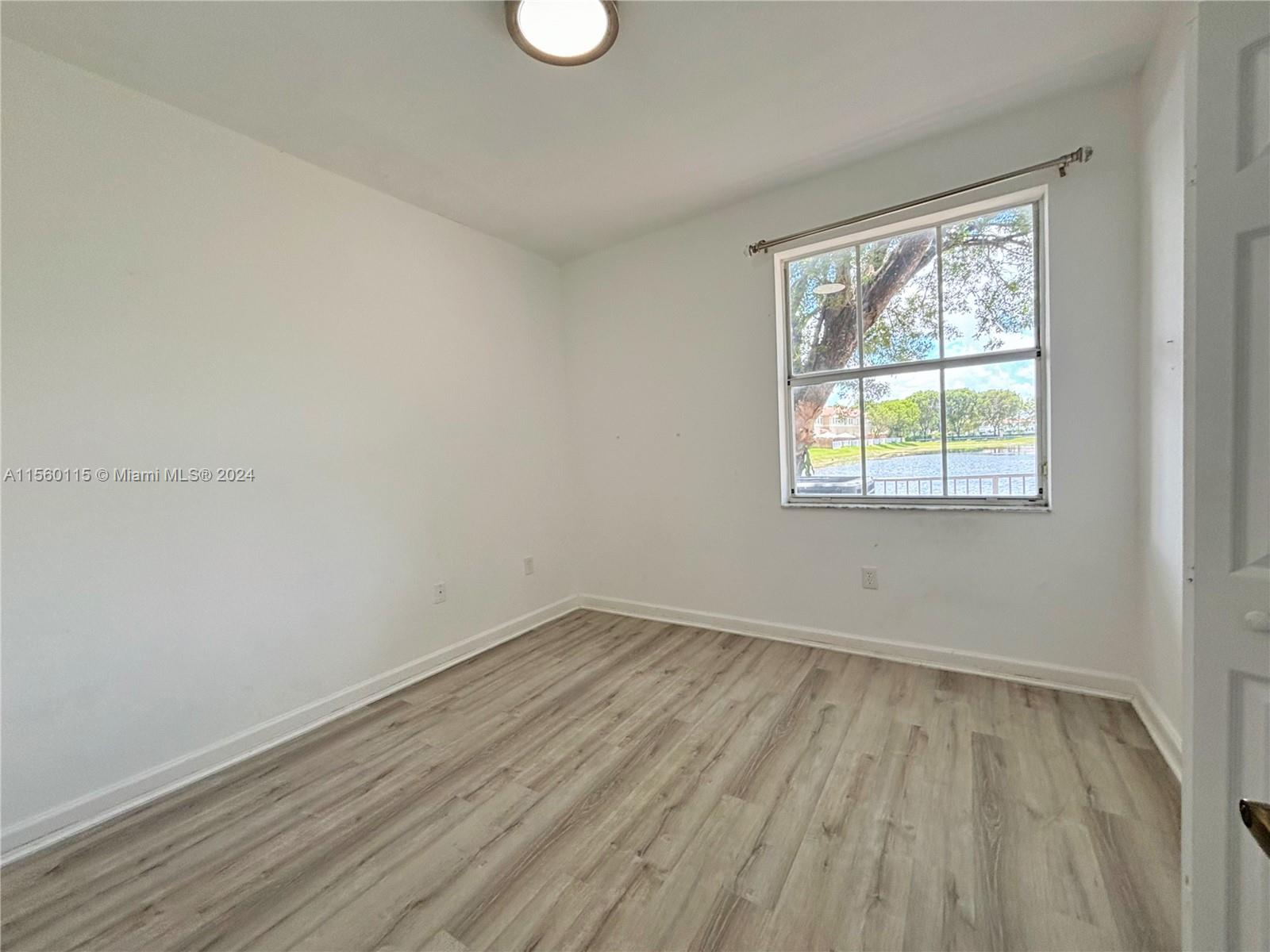 10860 Northwest 84th Street Doral, FL 33178 - Photo 18 of 19 an empty room with a window