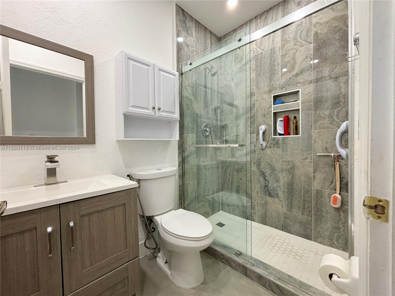 10860 Northwest 84th Street Doral, FL 33178 - Photo 4 of 19 a bathroom with a shower toilet and sink