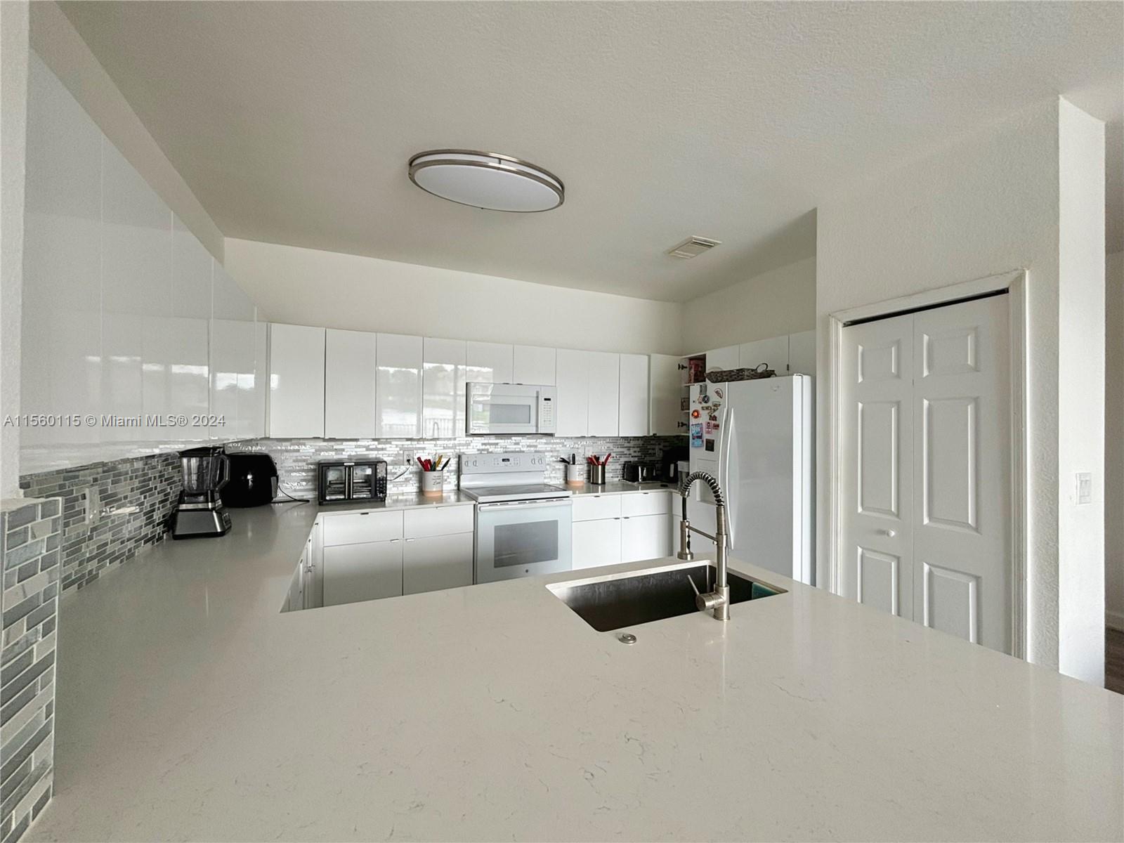 10860 Northwest 84th Street Doral, FL 33178 - Photo 6 of 19 a view of a living room kitchen and a window