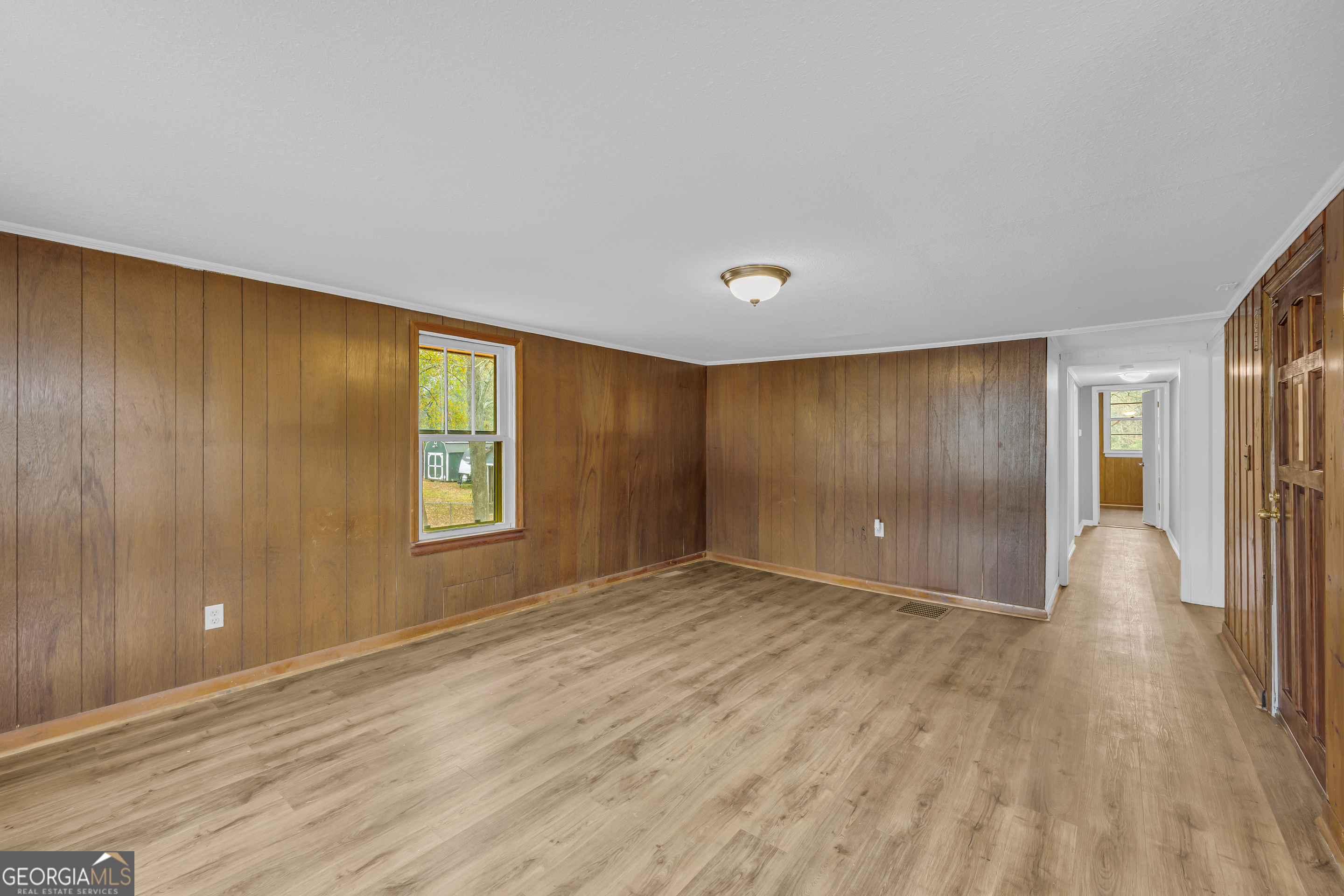 132 Queen Street Toccoa, GA 30577 - Photo 21 of 46 a view of an empty room with wooden floor and a window