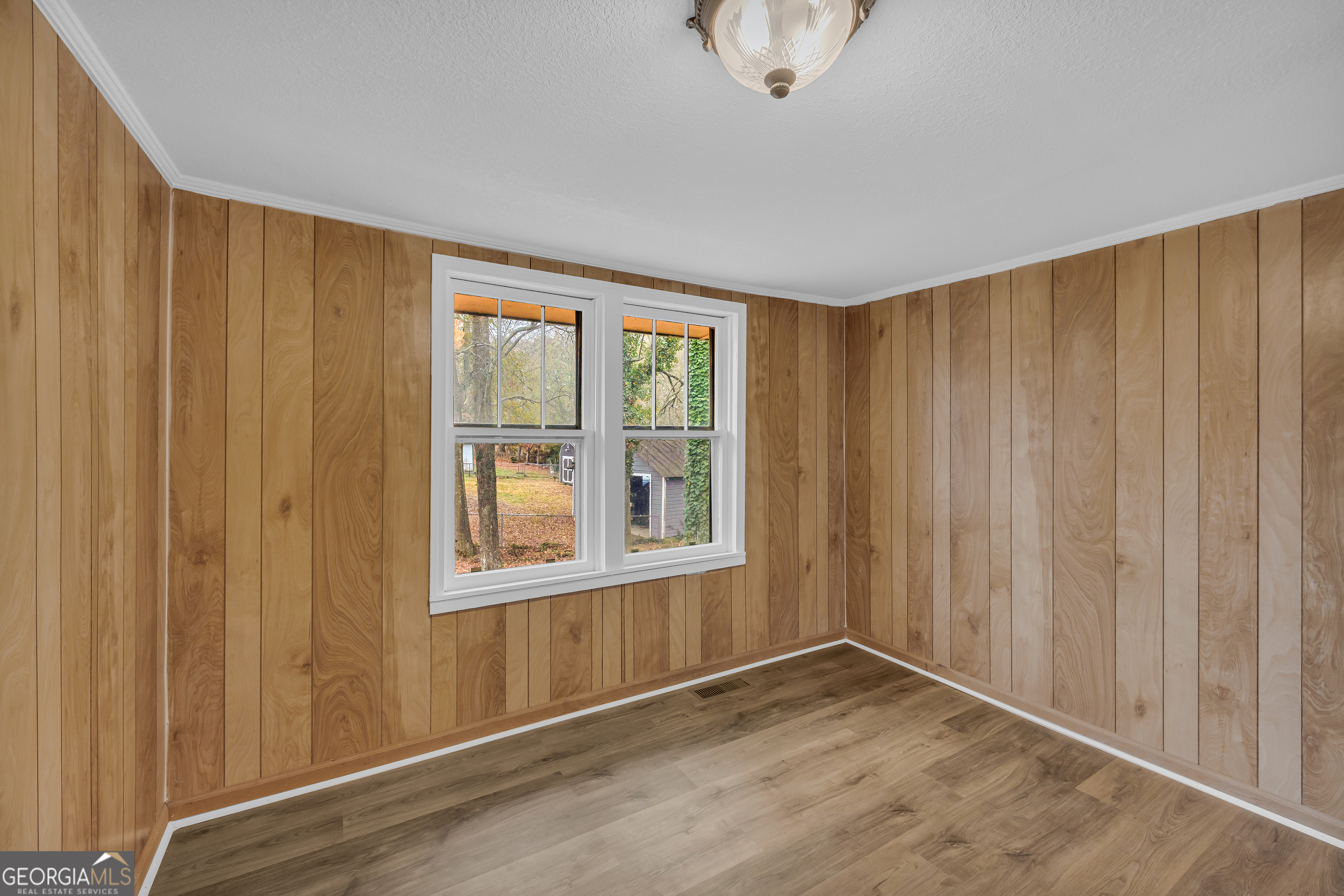132 Queen Street Toccoa, GA 30577 - Photo 22 of 46 a view of an empty room with wooden floor and a window