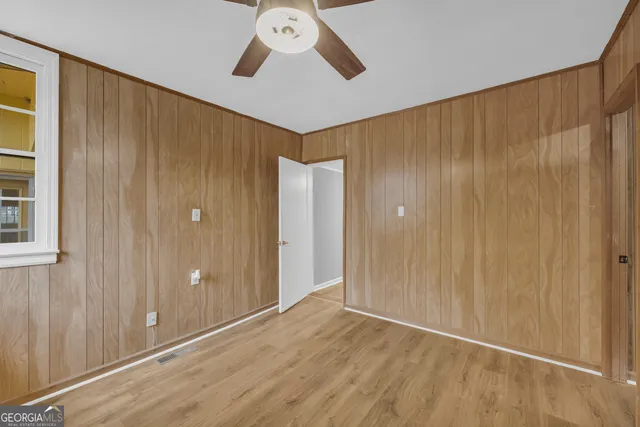 a view of an empty room with wooden floor