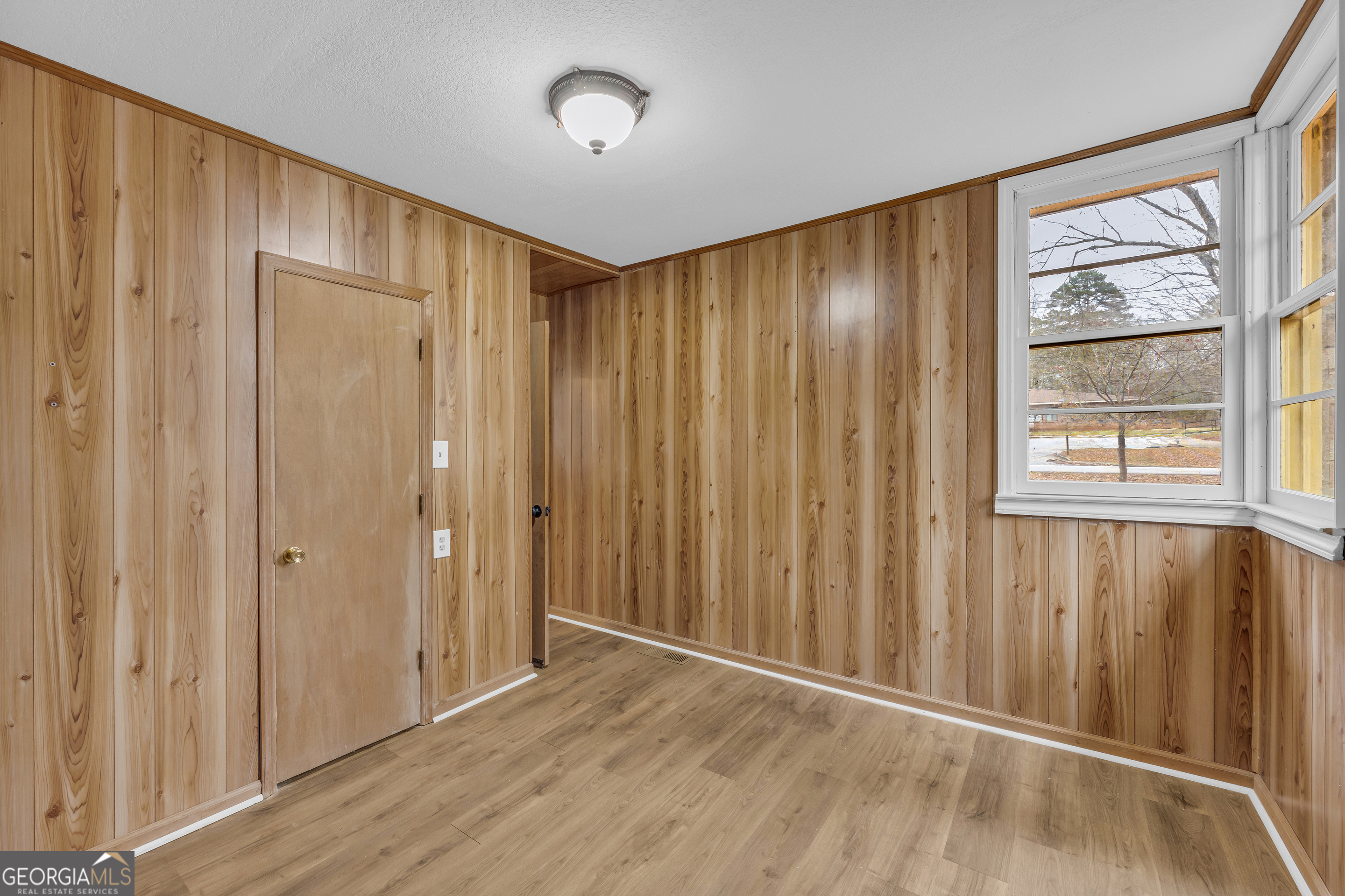 132 Queen Street Toccoa, GA 30577 - Photo 29 of 46 a view of an empty room with wooden floor and a window