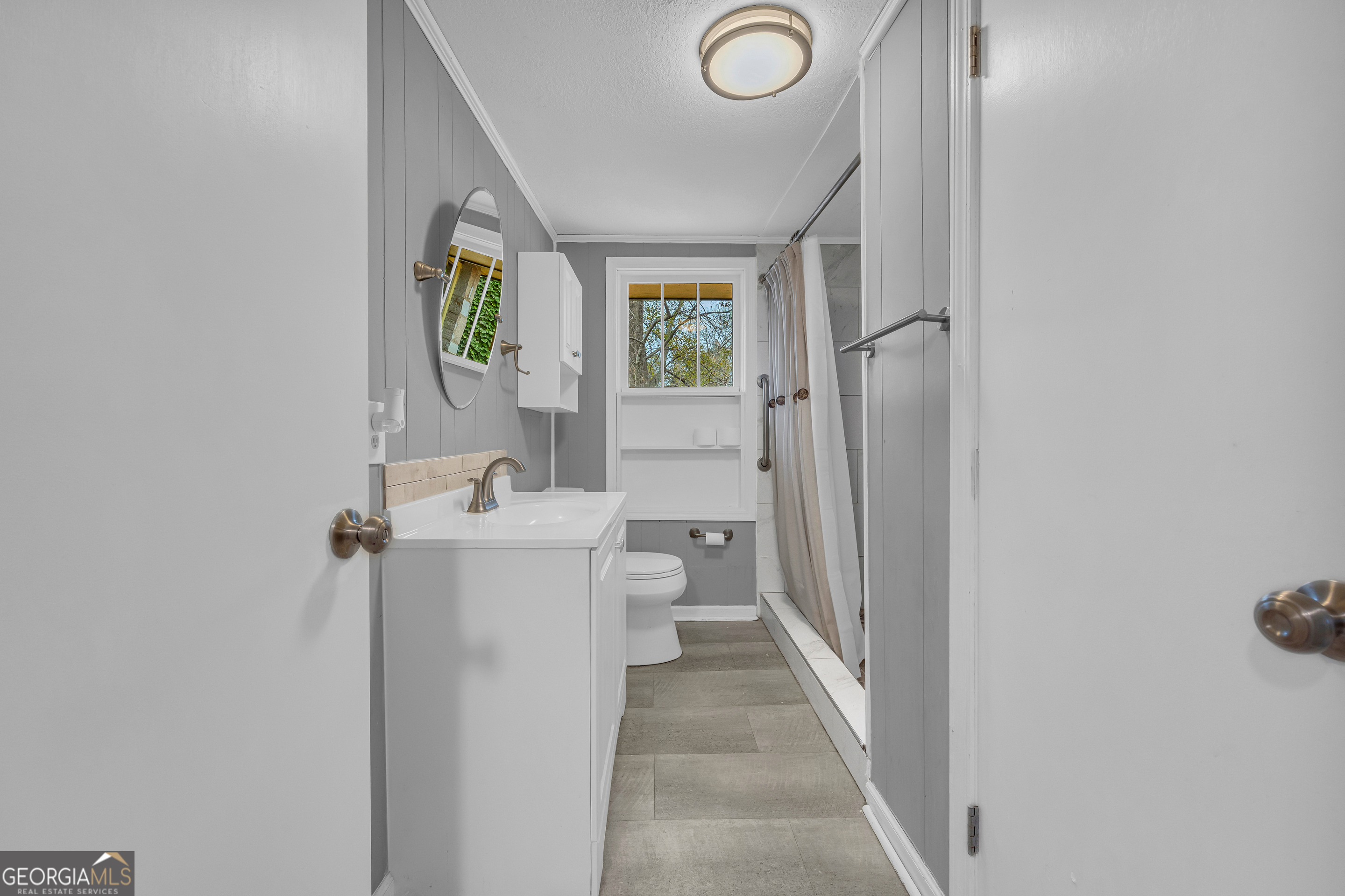 132 Queen Street Toccoa, GA 30577 - Photo 31 of 46 a bathroom with a sink a toilet a mirror and shower