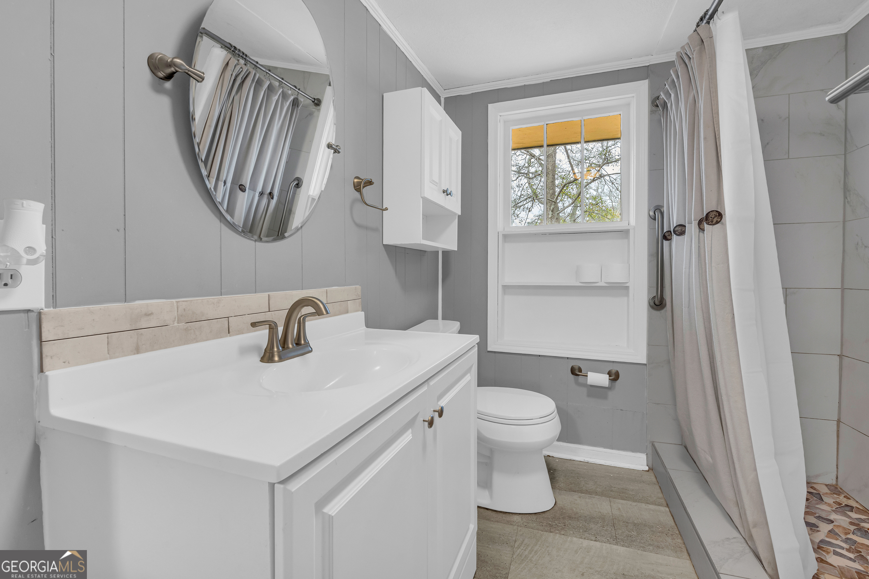 132 Queen Street Toccoa, GA 30577 - Photo 32 of 46 a bathroom with a sink a toilet and a mirror