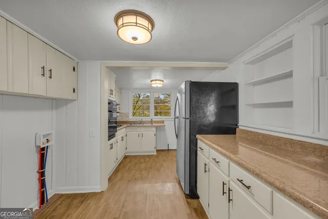 a kitchen with a refrigerator and a sink
