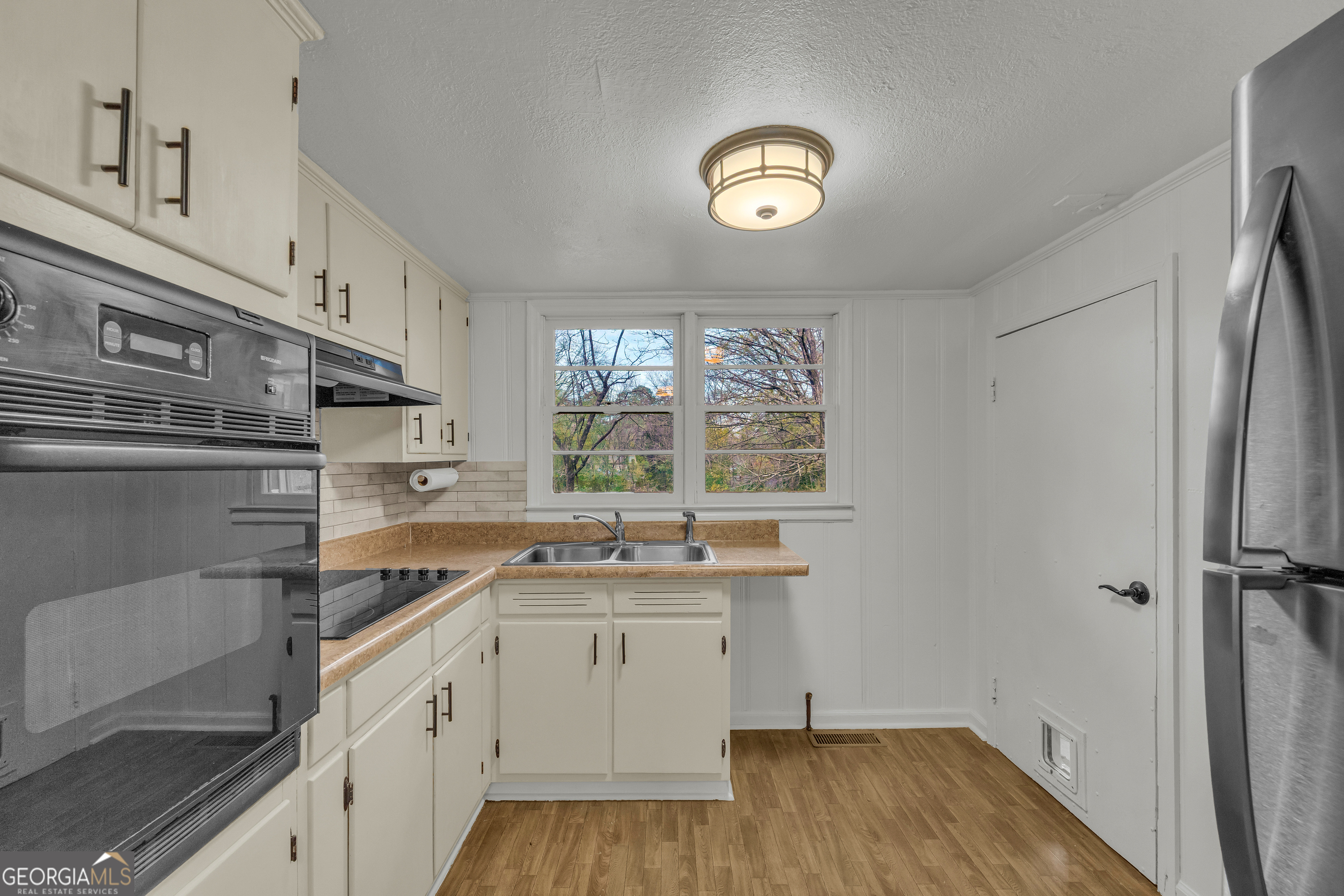 132 Queen Street Toccoa, GA 30577 - Photo 38 of 46 a kitchen with a sink window and cabinets