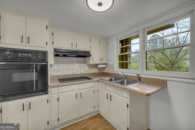 a kitchen with appliances cabinets and a sink