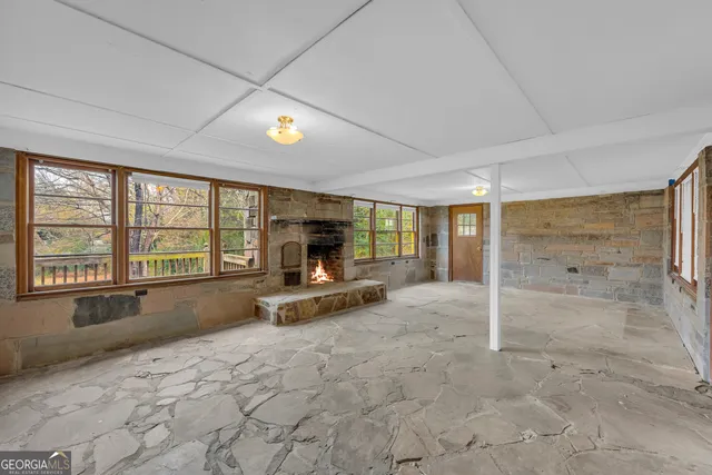 a view of an empty room with a fireplace