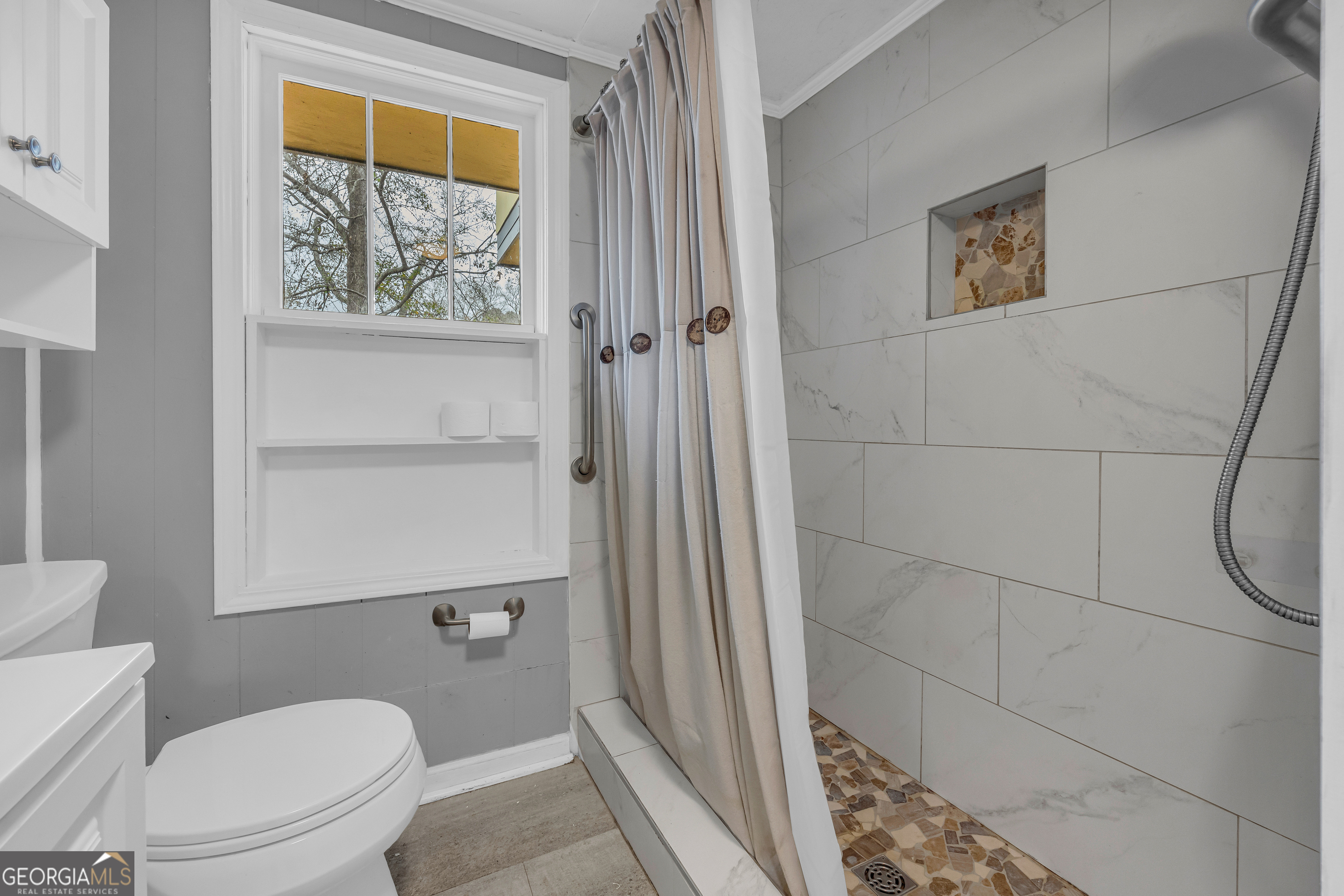 132 Queen Street Toccoa, GA 30577 - Photo 4 of 46 a white toilet sitting next to a shower