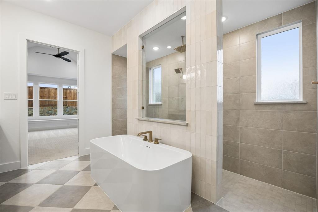 1120 Whirlabout Road Prosper, TX 75078 - Photo 14 of 25 You'll enjoy a spa like experience every day in this luxurious owner's bath featuring freestanding tube and double walk through shower.
