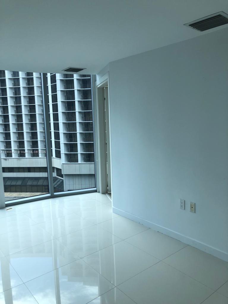 200 Biscayne Blvd Way, Unit 902 Miami, FL 33131 - Photo 4 of 23 a view of wooden floor and windows in a room
