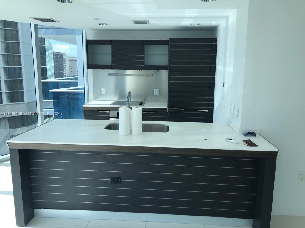 200 Biscayne Blvd Way, Unit 902 Miami, FL 33131 - Photo 6 of 23 a bathroom with a sink and a mirror