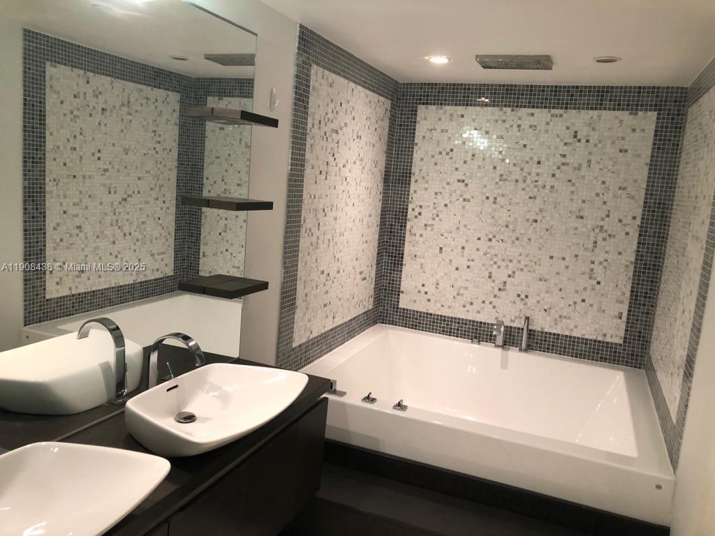 200 Biscayne Blvd Way, Unit 902 Miami, FL 33131 - Photo 7 of 23 a bathroom with a bathtub and a shower