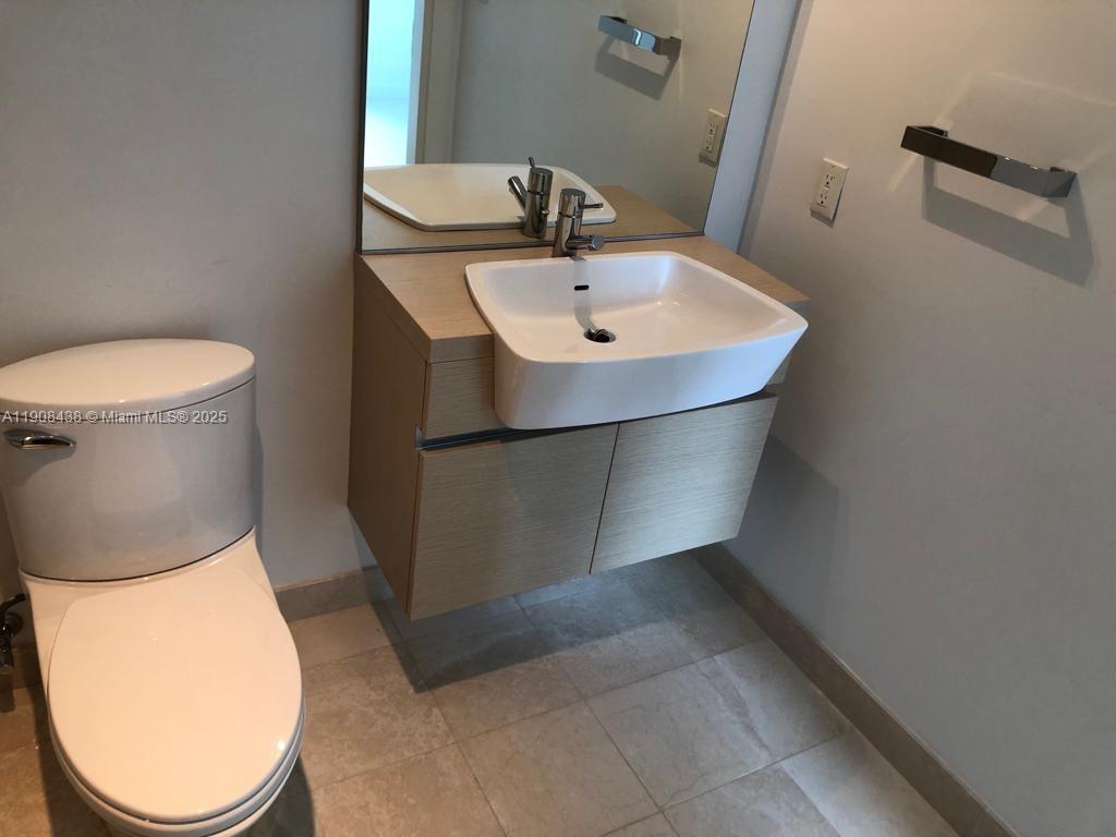 200 Biscayne Blvd Way, Unit 902 Miami, FL 33131 - Photo 9 of 23 a bathroom with a toilet and a sink