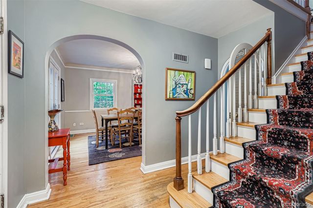 a view of entryway dining room and hall with wooden floor