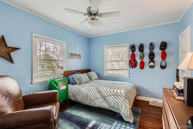 a bedroom with a bed couch and window