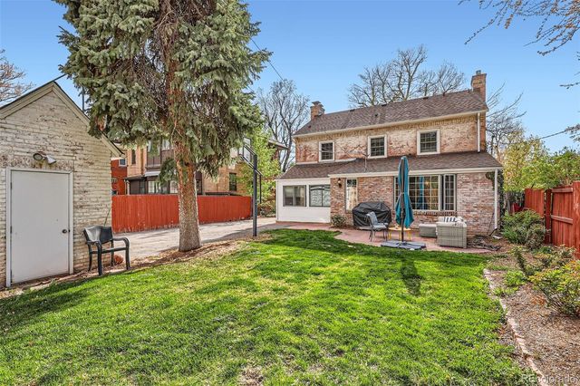 a front view of a house with a yard table and chairs