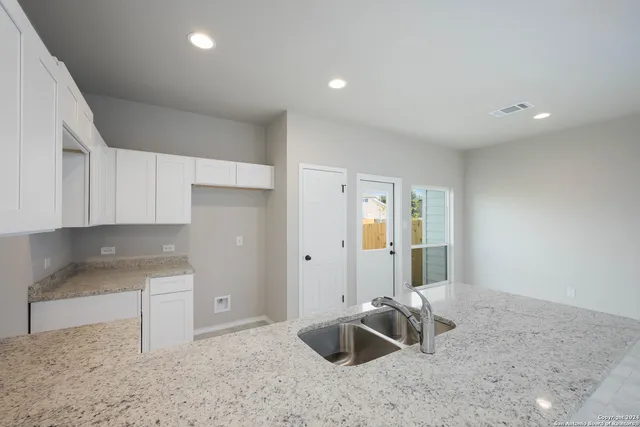 a kitchen with granite countertop a sink and granite top