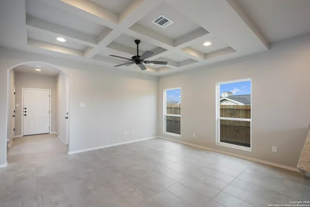 a view of a livingroom with a ceiling fan and window