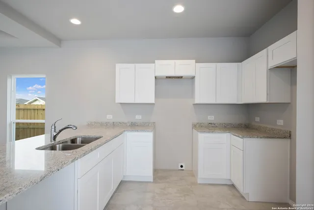 a kitchen that has a sink and cabinets