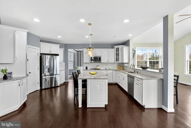 a living room with a fireplace and wooden floor
