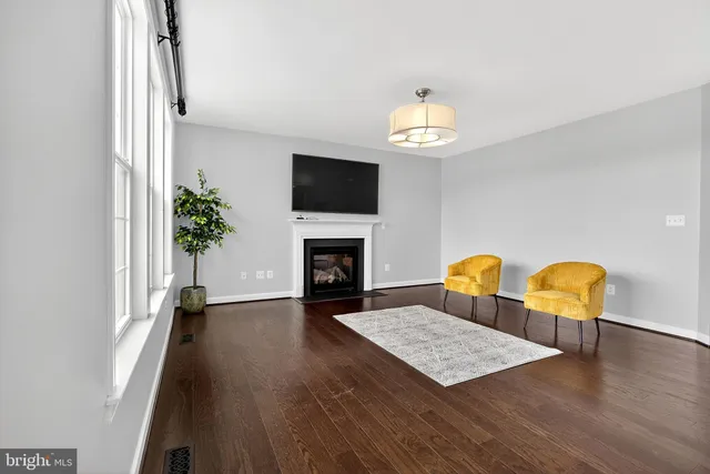 a spacious bedroom with a bed and a painting on the wall