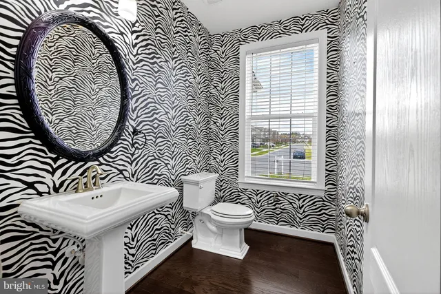 a view of a livingroom with wooden floor and a window