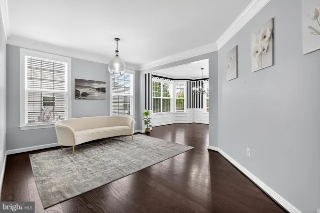 a kitchen with stainless steel appliances granite countertop a refrigerator a stove top oven a sink dishwasher and white cabinets with wooden floor